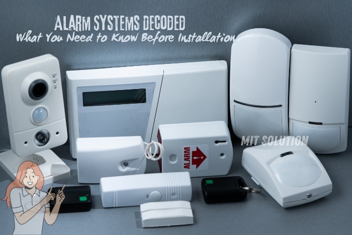 A variety of modern alarm system components, highlighting the essentials you need to know before installation, provided by MIT Solution in Dindigul, Tamil Nadu. The caption 'Alarm Systems Decoded: What You Need to Know Before Installation' emphasizes MIT Solution's expertise in offering comprehensive security solutions