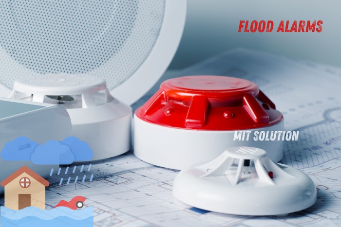 Close-up of flood alarm devices, showcasing advanced flood detection solutions offered by MIT Solution in Dindigul, Tamil Nadu. The caption 'Flood Alarms' highlights the importance of protecting properties from water damage with reliable alarm systems from MIT Solution